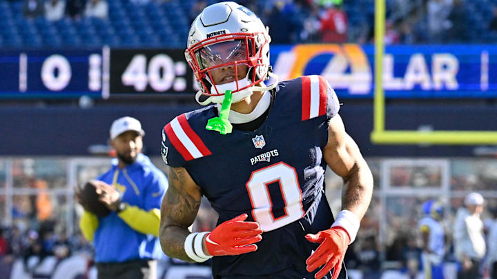 Nov 17, 2024; Foxborough, Massachusetts, USA;  New England Patriots cornerback Christian Gonzalez (0) warms up before a game against the Los Angeles Rams at Gillette Stadium. Mandatory Credit: Eric Canha-Imagn Images