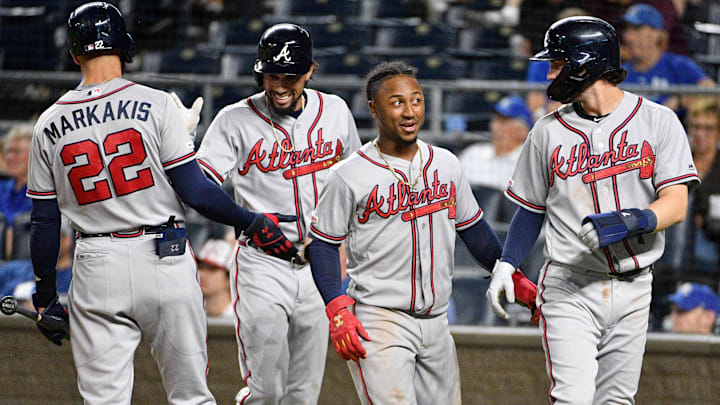 Former Atlanta Braves center fielder Billy Hamilton (9) and second baseman Ozzie Albies (1), and shortstop Dansby Swanson (7) celebrate with right fielder Nick Markakis (22) after scoring in the eighth inning against the Kansas City Royals at Kauffman Stadium.