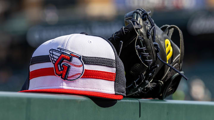 Jul 8, 2024; Detroit, Michigan, USA; A Cleveland Guardians baseball cap and glove sit on the dugout rail before the game against the Detroit Tigers at Comerica Park. Mandatory Credit: David Reginek-Imagn Images