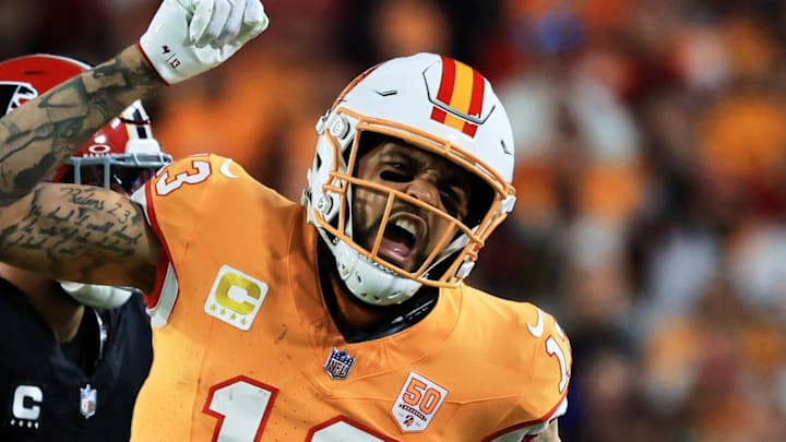 Dec 11, 2025; Tampa, Florida, USA; Tampa Bay Buccaneers wide receiver Mike Evans (13) reacts after catching a pass against Atlanta Falcons safety Jessie Bates III (3) (obscured) during the third quarter at Raymond James Stadium. Mandatory Credit: Kim Klement Neitzel-Imagn Images