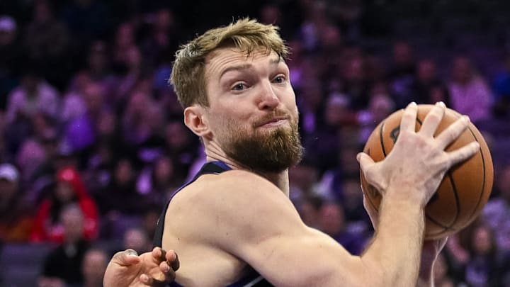 Feb 4, 2026; Sacramento, California, USA; Sacramento Kings forward/center Domantas Sabonis (11) rebounds tagainst Memphis Grizzlies guard Cedric Coward (23) during the third quarter at Golden 1 Center. Mandatory Credit: Ed Szczepanski-Imagn Images