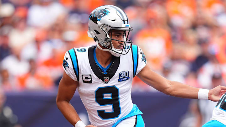 Oct 27, 2024; Denver, Colorado, USA;Carolina Panthers quarterback Bryce Young (9) hands the ball off to running back Chuba Hubbard (30) in the first half against the Denver Broncos at Empower Field at Mile High. Mandatory Credit: Ron Chenoy-Imagn Images Oct 27, 2024; Denver, Colorado, USA;Carolina Panthers quarterback Bryce Young (9) hands the ball off to running back Chuba Hubbard (30) in the first half against the Denver Broncos at Empower Field at Mile High. Mandatory Credit: Ron Chenoy-Imagn Images