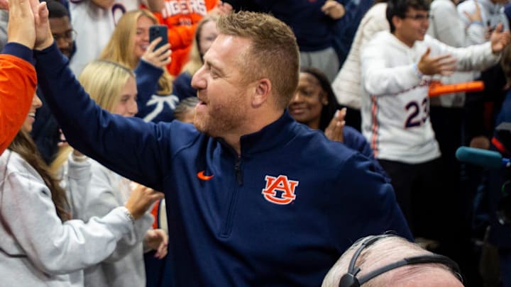 Newly hired Auburn football head coach Alex Golesh greets fans before Auburn Tigers take on NC State Wolfpack at Neville Arena in Auburn, Ala. on Wednesday, Dec. 3, 2025.