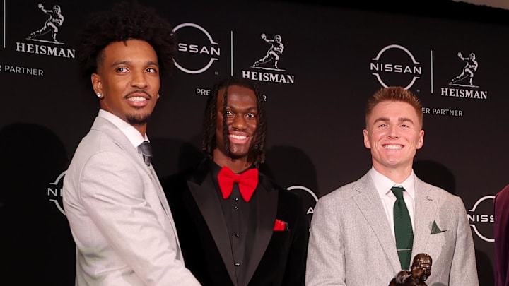 Dec 9, 2023; New York, New York, USA; Heisman hopefuls (left to right) LSU Tigers quarterback Jayden Daniels and Ohio State Buckeyes wide receiver Marvin Harrison Jr. and Oregon Ducks quarterback Bo Nix and Washington Huskies quarterback Michael Penix Jr. pose with the Heisman trophy during a press conference in the Astor ballroom at the New York Marriott Marquis before the presentation of the Heisman trophy. Mandatory Credit: Brad Penner-Imagn Images