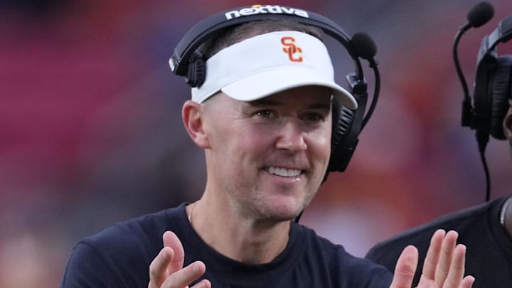 Sep 2, 2023; Los Angeles, California, USA; Southern California Trojans head coach Lincoln Riley (leff) and wide receivers coach Dennis Simmons react against the Nevada Wolf Pack in the second half at United Airlines Field at Los Angeles Memorial Coliseum. Mandatory Credit: Kirby Lee-Imagn Images