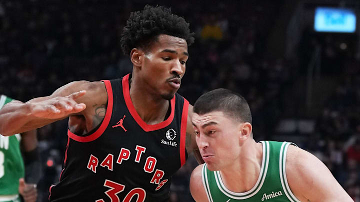 Boston Celtics guard Payton Pritchard controls the ball as Toronto Raptors guard Ochai Agbaji tries to defend