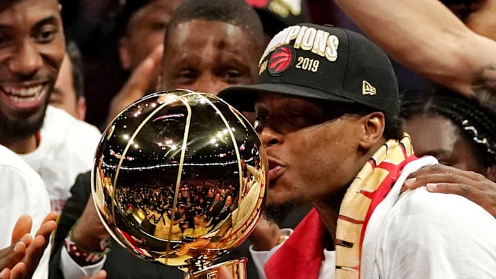 Toronto Raptors guard Kyle Lowry kisses the Larry O'Brien Trophy after beating the Golden State Warriors.