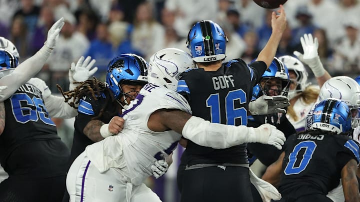 Minnesota Vikings defensive tackle Javon Hargrave (97) tackles Detroit Lions quarterback Jared Goff (16).
