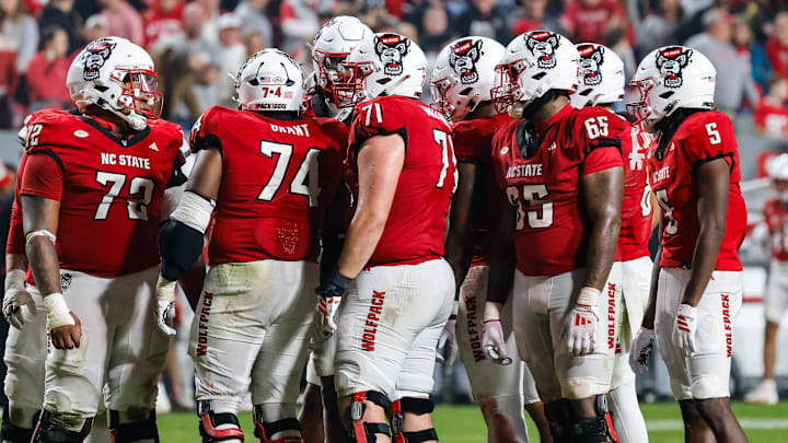 Nov 21, 2025; Raleigh, North Carolina, USA; NC State Wolfpack huddles during the second half of the game against Florida State Seminoles at Carter-Finley Stadium. Mandatory Credit: Jaylynn Nash-Imagn Images