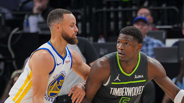 Mar 24, 2024; Minneapolis, Minnesota, USA; Golden State Warriors guard Stephen Curry (30) defends Minnesota Timberwolves guard Anthony Edwards (5) in the third quarter at Target Center. Mandatory Credit: Brad Rempel-Imagn Images