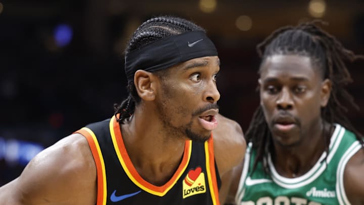 Jan 5, 2025; Oklahoma City, Oklahoma, USA; Oklahoma City Thunder guard Shai Gilgeous-Alexander (2) moves the ball around Boston Celtics guard Jrue Holiday (4) during the fourth quarter at Paycom Center. Mandatory Credit: Alonzo Adams-Imagn Images