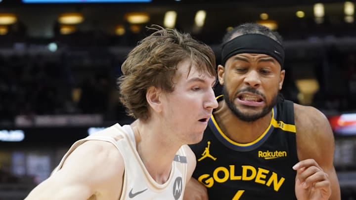 Feb 8, 2025; Chicago, Illinois, USA; Golden State Warriors guard Moses Moody (4) defends Chicago Bulls forward Matas Buzelis (14) during the second half at United Center. Mandatory Credit: David Banks-Imagn Images