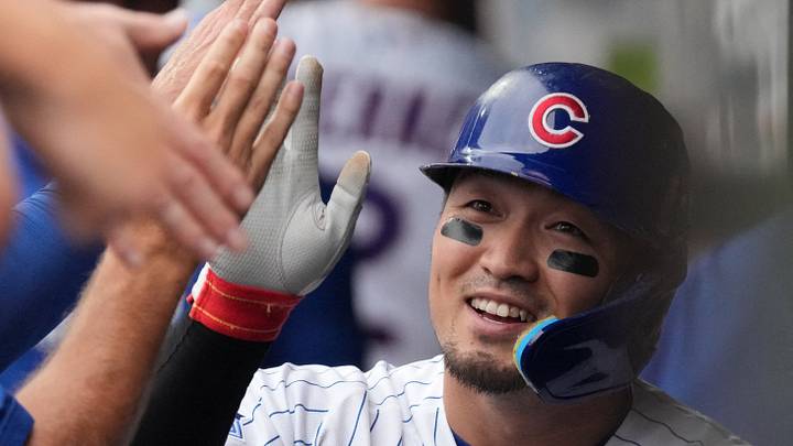 Aug 5, 2026; Chicago, Illinois, USA; Chicago Cubs right fielder Seiya Suzuki (27) is greeted after scoring against the Los Angeles Dodgers during the fourth inning at Wrigley Field. Mandatory Credit: David Banks-Imagn Images
