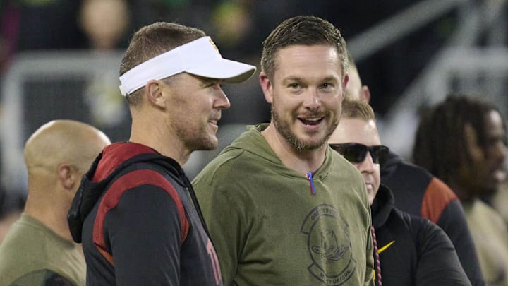 Nov 11, 2023; Eugene, Oregon, USA; USC Trojans head coach Lincoln Riley, left, and Oregon Ducks head coach Dan Lanning talk before a game at Autzen Stadium. Mandatory Credit: Troy Wayrynen-Imagn Images Nov 11, 2023; Eugene, Oregon, USA; USC Trojans head coach Lincoln Riley, left, and Oregon Ducks head coach Dan Lanning talk before a game at Autzen Stadium. Mandatory Credit: Troy Wayrynen-Imagn Images