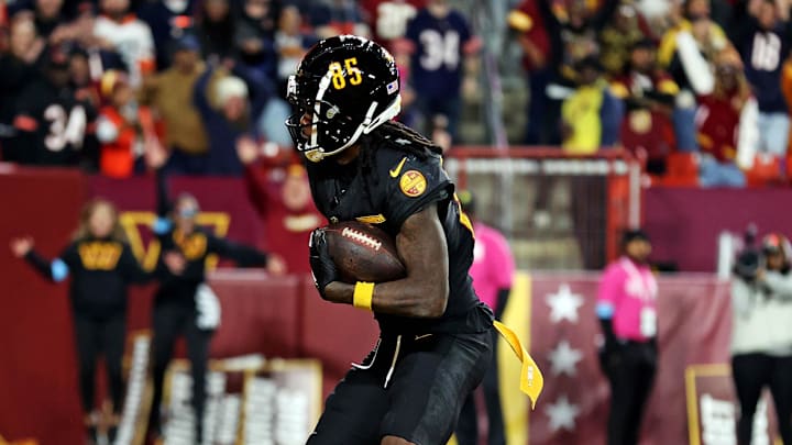 Oct 27, 2024; Landover, Maryland, USA; Washington Commanders wide receiver Noah Brown (85) catches a Hail Mary pass with no time left to beat the Chicago Bears at Commanders Field. Mandatory Credit: Peter Casey-Imagn Images