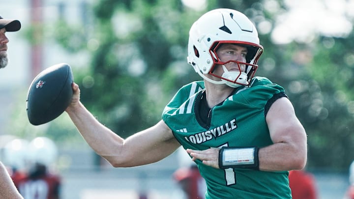 Louisville Cardinals quarterback Miller Moss during a morning practice Wednesday, July 30, 2025. Moss transferred from USC. His overall QB rating is 81.4. At left is UofL quarterbacks coach and offensive coordinator Brian Brohm.