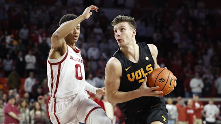 Feb 8, 2025; Norman, Oklahoma, USA; Tennessee Volunteers forward Igor Milicic Jr. (7) drives around Oklahoma Sooners guard Jeremiah Fears (0) during the first half at Lloyd Noble Center. Mandatory Credit: Alonzo Adams-Imagn Images