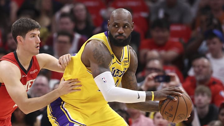Apr 24, 2026; Houston, Texas, USA; Los Angeles Lakers forward LeBron James (23) controls the ball as Los Angeles Lakers guard Austin Reaves (15) defends during the first quarter during game three of the first round of the 2026 NBA Playoffs at Toyota Center. Mandatory Credit: Troy Taormina-Imagn Images