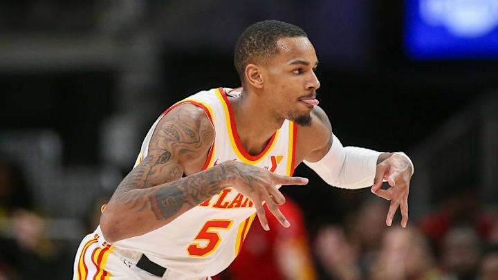 Jan 10, 2024; Atlanta, Georgia, USA; Atlanta Hawks guard Dejounte Murray (5) reacts after a three-pointer against the Philadelphia 76ers in the second quarter at State Farm Arena. Mandatory Credit: Brett Davis-Imagn Images
