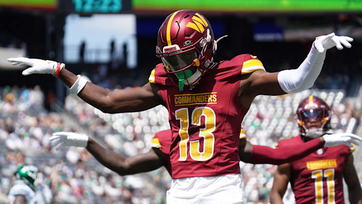 Aug 10, 2024; East Rutherford, New Jersey, USA; Washington Commanders cornerback Emmanuel Forbes (13) celebrates after breaking up a pass to New York Jets wide receiver Mike Williams (18) during the first quarter at MetLife Stadium. Mandatory Credit: Lucas Boland-Imagn Images