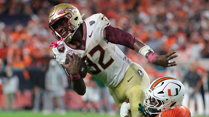 Oct 17, 2026; Miami Gardens, Florida, USA;  Florida State Seminoles running back Ousmane Kromah (32) is tackled by Miami Hurricanes linebacker Mohamed Toure (1) during the second quarter at Hard Rock Stadium.  Mandatory Credit: Sam Navarro-Imagn Images