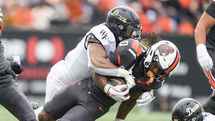 Oct 11, 2025; Corvallis, Oregon, USA; Oregon State Beavers running back Anthony Hankerson (0) is tacked after a run by Wake Forest Demon Deacons linebacker Langston Hardy (11) during the second half at Reser Stadium. Mandatory Credit: Craig Strobeck-Imagn Images Oct 11, 2025; Corvallis, Oregon, USA; Oregon State Beavers running back Anthony Hankerson (0) is tacked after a run by Wake Forest Demon Deacons linebacker Langston Hardy (11) during the second half at Reser Stadium. Mandatory Credit: Craig Strobeck-Imagn Images