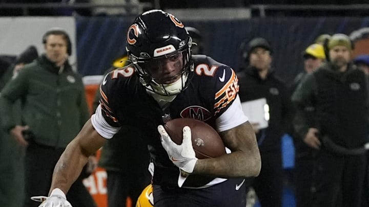 Jan 10, 2026; Chicago, IL, USA;  Chicago Bears wide receiver DJ Moore (2) runs after the catch as Green Bay Packers safety Evan Williams (33) defends during the first half of an NFC Wild Card Round game at Soldier Field. Mandatory Credit: David Banks-Imagn Images
