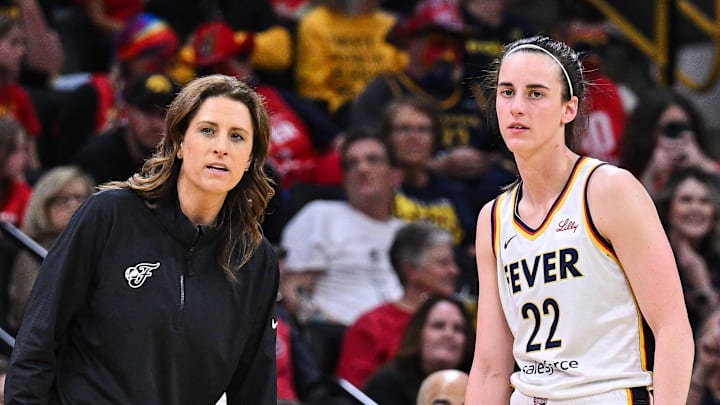 Indiana Fever guard Caitlin Clark (22) looks on with head coach Stephanie White