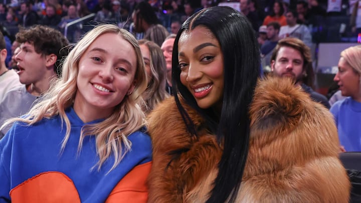 Dec 7, 2025; New York, New York, USA;  WNBA players Paige Bueckers (l) and Angel Reese (r) sit courtside during the game between the Orlando Magic and the New York Knicks at Madison Square Garden. Mandatory Credit: Wendell Cruz-Imagn Images