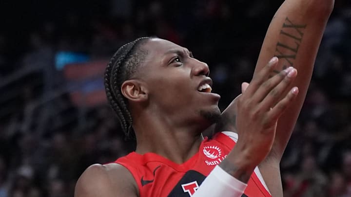 Toronto Raptors forward RJ Barrett attempts a shot at the basket over Dallas Mavericks forward Khris Middleton.