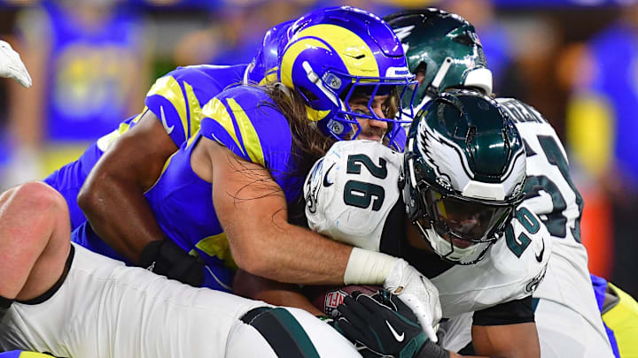 Nov 24, 2024; Inglewood, California, USA; Philadelphia Eagles running back Saquon Barkley (26) is brought down by Los Angeles Rams linebacker Christian Rozeboom (56) during the second half at SoFi Stadium. Mandatory Credit: Gary A. Vasquez-Imagn Images
