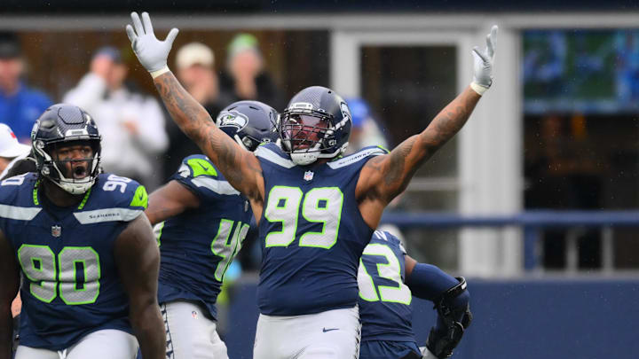 Nov 24, 2024; Seattle, Washington, USA; Seattle Seahawks defensive tackle Jarran Reed (90) and defensive end Leonard Williams (99) celebrate after a defensive play against the Arizona Cardinals during the first half at Lumen Field. Mandatory Credit: Steven Bisig-Imagn Images