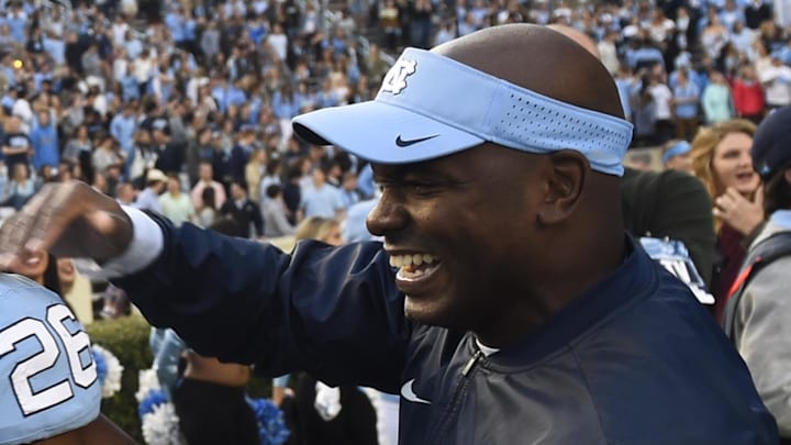 Nov 19, 2016; Chapel Hill, NC, USA; North Carolina Tar Heels safety Dominquie Green (26) reacts with defensive coach Charlton Warren on the sidelines after intercepting a pass and returning it for a touchdown in the second quarter at Kenan Memorial Stadium. Mandatory Credit: Bob Donnan-Imagn Images Nov 19, 2016; Chapel Hill, NC, USA; North Carolina Tar Heels safety Dominquie Green (26) reacts with defensive coach Charlton Warren on the sidelines after intercepting a pass and returning it for a touchdown in the second quarter at Kenan Memorial Stadium. Mandatory Credit: Bob Donnan-Imagn Images