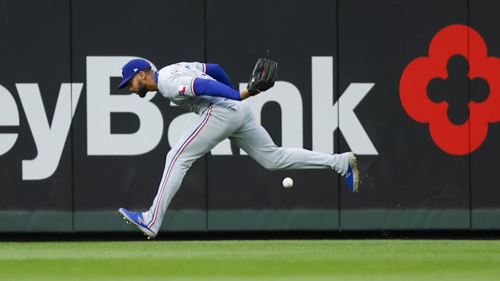 Apr 12, 2025; Seattle, Washington, USA; Texas Rangers center fielder Leody Taveras (3) fails to field a triple against the Seattle Mariners during the third inning at T-Mobile Park. Apr 12, 2025; Seattle, Washington, USA; Texas Rangers center fielder Leody Taveras (3) fails to field a triple against the Seattle Mariners during the third inning at T-Mobile Park.