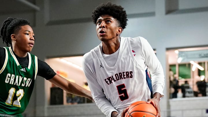 Columbus Explorers guard Jaxon Richardson (5) drives to the basket as Grayson Rams guard Blaze Johnson (12) guards him during the third quarter of a City of Palms Classic quarterfinal game at Suncoast Credit Union Arena in Fort Myers, Fla., on Friday, Dec. 20, 2024. Columbus Explorers guard Jaxon Richardson (5) drives to the basket as Grayson Rams guard Blaze Johnson (12) guards him during the third quarter of a City of Palms Classic quarterfinal game at Suncoast Credit Union Arena in Fort Myers, Fla., on Friday, Dec. 20, 2024.