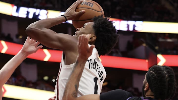 Jan 5, 2025; Houston, Texas, USA; Houston Rockets forward Amen Thompson (1) grabs an offensive rebound against Los Angeles Lakers guard Austin Reaves (15) in the second quarter at Toyota Center. Mandatory Credit: Thomas Shea-Imagn Images