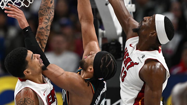 Jan 1, 2026; Detroit, Michigan, USA; Detroit Pistons guard Cade Cunningham (2) shoots the ball between Miami Heat centers Kel'El Ware (left) and Bam Adebayo (13) in the third quarter at Little Caesars Arena. Mandatory Credit: Lon Horwedel-Imagn Images