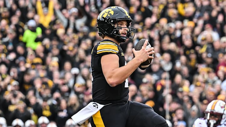 Oct 25, 2025; Iowa City, Iowa, USA; Iowa Hawkeyes quarterback Mark Gronowski (11) runs for a touchdown during the first quarter against the Minnesota Golden Gophers at Kinnick Stadium. Mandatory Credit: Jeffrey Becker-Imagn Images Oct 25, 2025; Iowa City, Iowa, USA; Iowa Hawkeyes quarterback Mark Gronowski (11) runs for a touchdown during the first quarter against the Minnesota Golden Gophers at Kinnick Stadium. Mandatory Credit: Jeffrey Becker-Imagn Images