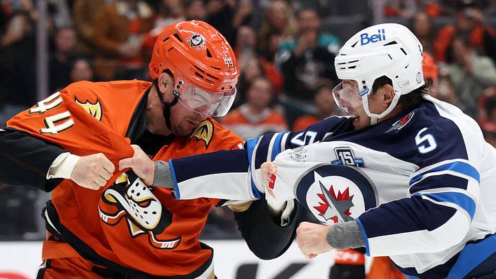 Feb 27, 2026; Anaheim, California, USA;  Anaheim Ducks left wing Ross Johnston (44) and Winnipeg Jets defenseman Luke Schenn (5) fight in the first period at Honda Center. Mandatory Credit: Kiyoshi Mio-Imagn Images