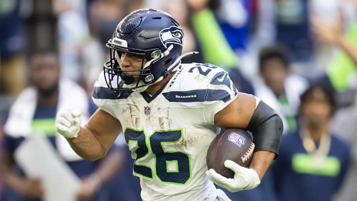 Dec 8, 2024; Glendale, Arizona, USA; Seattle Seahawks running back Zach Charbonnet (26) runs for a touchdown against the Arizona Cardinals in the first half at State Farm Stadium.