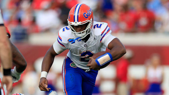Florida Gators quarterback DJ Lagway (2) rushes for yards against Georgia Bulldogs linebacker CJ Allen (3) during the second quarter of an NCAA college football matchup Saturday, Nov. 2, 2024 at EverBank Stadium in Jacksonville, Fla. The Georgia Bulldogs defeated the Florida Gators 34-20. [Corey Perrine/Florida Times-Union]