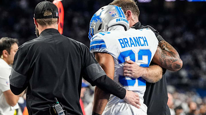 Detroit Lions safety Brian Branch (32), with the help of Lions staff, walks off the field due to an injury during the second half against the Dallas Cowboys at Ford Field in Detroit on Thursday, Dec. 4, 2025. Detroit Lions safety Brian Branch (32), with the help of Lions staff, walks off the field due to an injury during the second half against the Dallas Cowboys at Ford Field in Detroit on Thursday, Dec. 4, 2025.