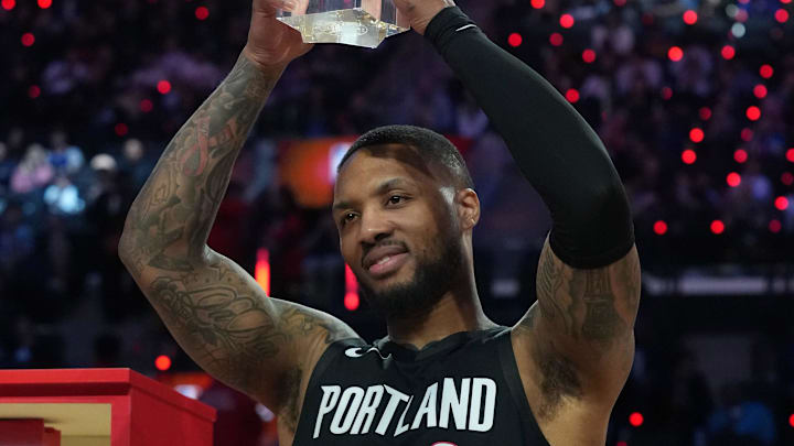 Portland Trail Blazers guard Damian Lillard holds the trophy after winning the three point contest.