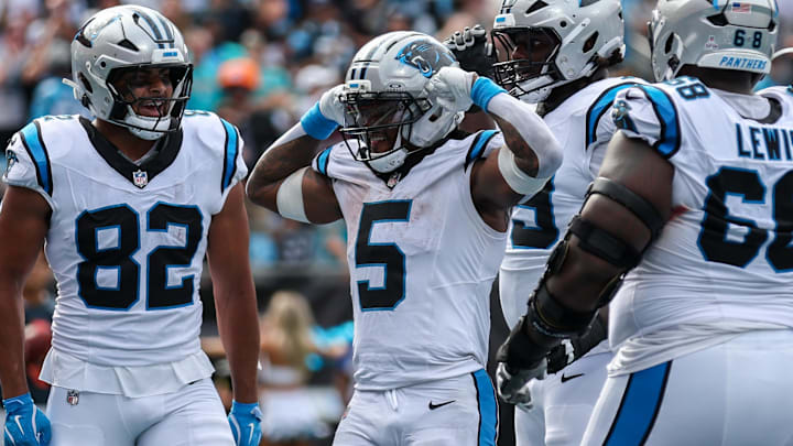 Carolina Panthers running back Rico Dowdle (5) reacts after scoring a touchdown with Carolina Panthers tight end Tommy Tremble (82) and Carolina Panthers tight end Mitchell Evans (84) during the fourth quarter against the Miami Dolphins at Bank of America Stadium.