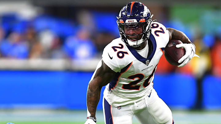Oct 17, 2022; Inglewood, California, USA; Denver Broncos running back Mike Boone (26) runs the ball ahead of Los Angeles Chargers linebacker Drue Tranquill (49) during the second half at SoFi Stadium. 