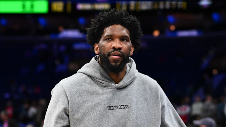 Philadelphia 76ers center Joel Embiid stands on the sidelines.