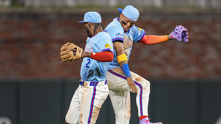 Apr 12, 2026; Cumberland, Georgia, USA; Atlanta Braves right fielder Ronald Acuna Jr. (13) and shortstop Jorge Mateo (2) react after defeating the Cleveland Guardians at Truist Park. Mandatory Credit: Dale Zanine-Imagn Images