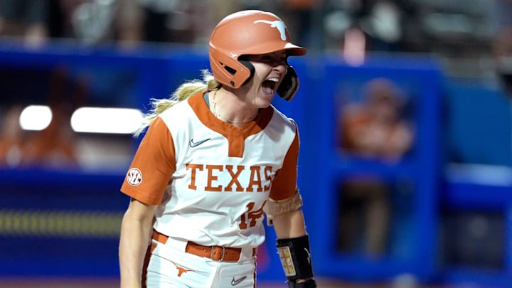Texas Longhorns catcher Reese Atwood celebrates as she drives in two runs on a single in the sixth inning of Game 1 of the Women's College World Series.