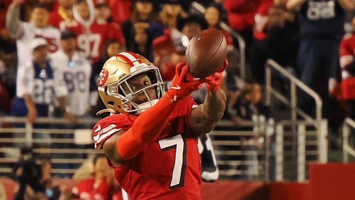 San Francisco 49ers cornerback Charvarius Ward attempts to gather the ball on a Dallas Cowboys pass.