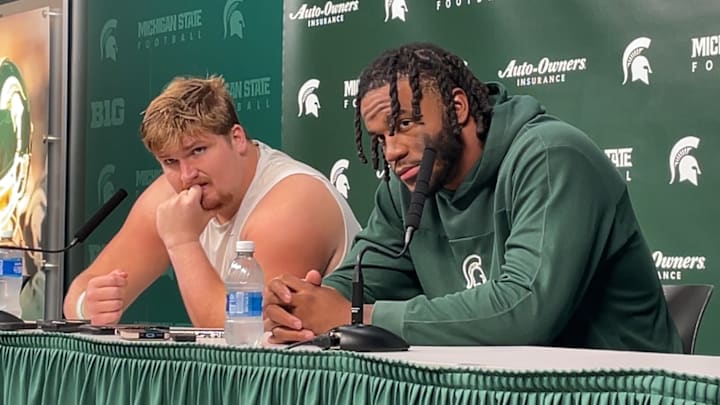 Michigan State center Matt Gulbin (left) and linebacker Jordan Hall (right) discuss the Spartans' 38-13 loss to UCLA after the game on Oct. 11, 2025.